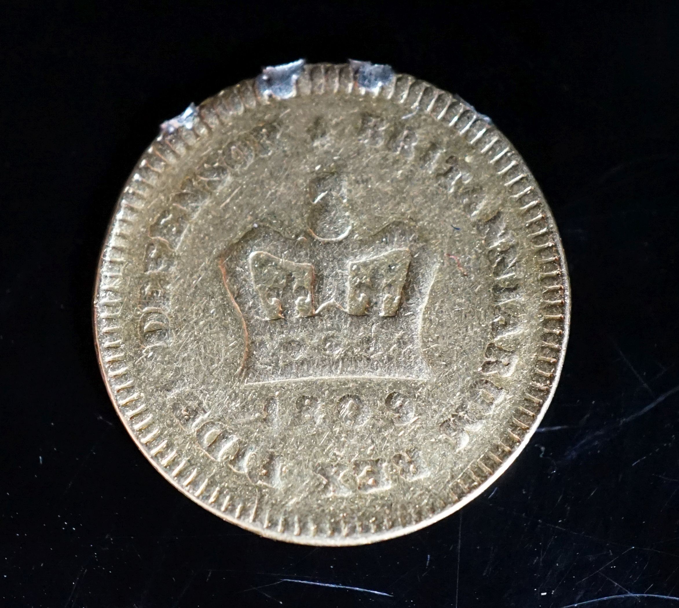 A George III 1809 gold one third guinea coin.